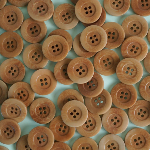 Pattern of wooden buttons on a light blue background
