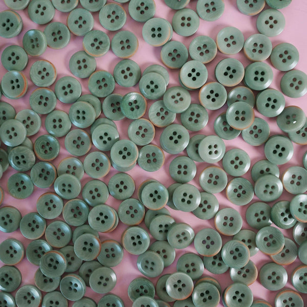 Green buttons on a pink background
