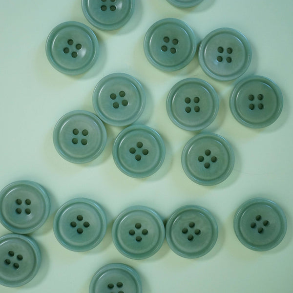 Multiple light blue-green buttons arranged in a grid on a light green background