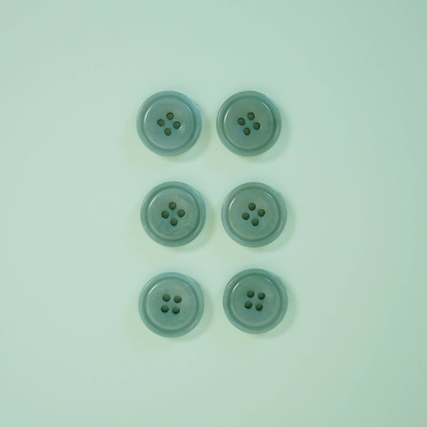 Five light blue-green buttons on a matching light blue background