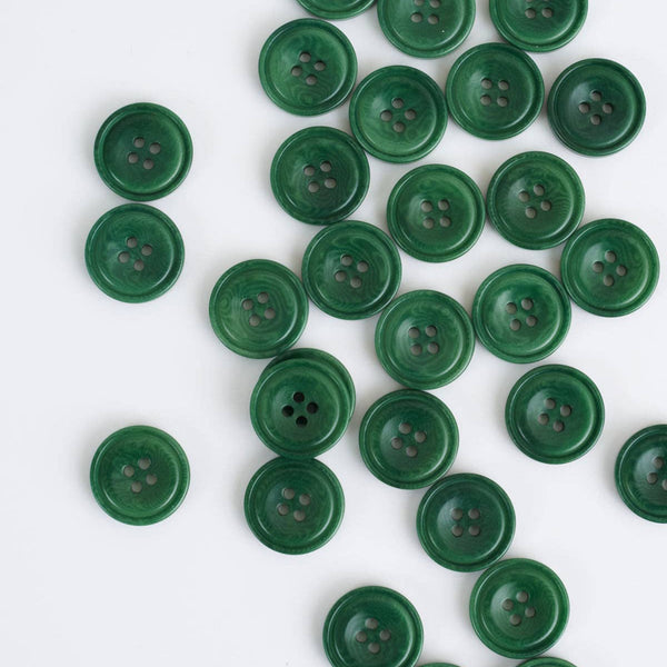 Green buttons scattered on a white background