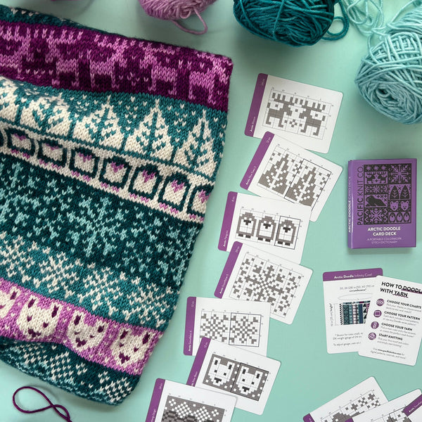 Knitted swatches and yarn with pattern cards on a light green background