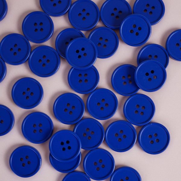 Multiple blue buttons scattered on a light gray background
