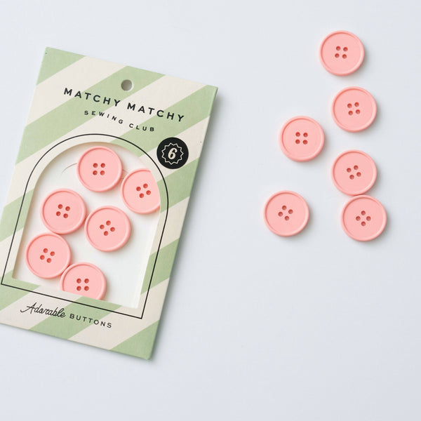 Pink buttons with a 'Matchy Matchy Sewing Club' packaging on a light gray background