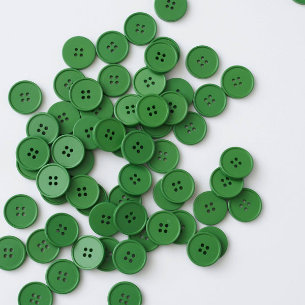 Pile of green buttons on a white background