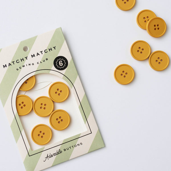 Yellow buttons with packaging on a light gray background