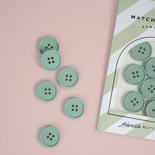 Green buttons on a pink background with a box labeled 'Adesable Buttons' in the corner.